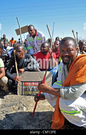 RUSTENBURG, SOUTH AFRICA: Lonmin mine workers march to three different mines demanding that shafts be closed down and workers join them in their wage strike on September 10, 2012 in Rustenburg, South Africa. The workers have been protesting for over three weeks. (Photo by Gallo Images / Dino Lloyd) Stock Photo