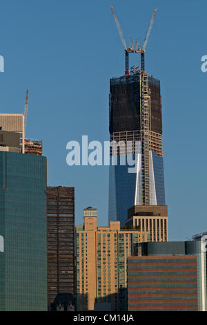 New York, USA. 11th September 2012. As seen from Brooklyn Heights, the One World Trade Center tower rises above the skyline of lower Manhattan on the morning of September 11, 2012.  The new building remains a work in progress on the eleventh anniversary of the September 11, 2001, terrorist attacks that leveled the World Trade Center Towers, which stood on the same site. Stock Photo