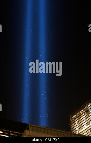 New York, NY - September 11, 2012: The twin columns of light of the installation 'Tribute in Light' rise into the night sky over Manhattan in memory of the 9/11 attacks 11 years ago. Stock Photo