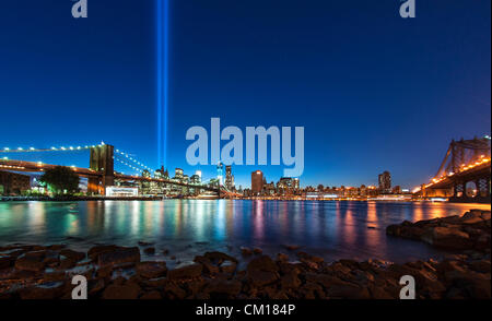 New York, NY - September 11, 2012: Two columns of light , an anual installation called 'Tribute in Light',  rise into the night sky over the Brooklyn Bridge and Manhattan in memory of the 9/11 attacks 11 years ago. Credit:  Arny Raedts / Alamy Live News Stock Photo