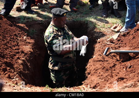 Soweto, South Africa. 11th September 2012. Bones believed to be those of Nceba Sinuma being exhumed on September 11, 2012 at Avalon Cemetery in Soweto, South Africa. Sinuma was one of the “Mofolo 3” who were killed by apartheid agents in a security operation in 1989. The Mofolo 3 were members of the Soweto Youth Congress and were involved in underground uMkhonto weSizwe activities. The body exhumed will be sent for DNA testing. (Photo by Gallo Images / Sowetan / Vathiswa Ruselo/Alamy Live News) Stock Photo