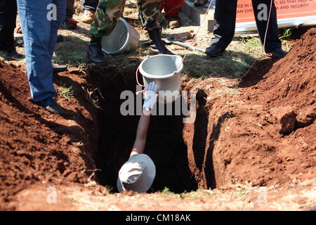 Soweto, South Africa. 11th September 2012. Bones believed to be those of Nceba Sinuma being exhumed on September 11, 2012 at Avalon Cemetery in Soweto, South Africa. Sinuma was one of the “Mofolo 3” who were killed by apartheid agents in a security operation in 1989. The Mofolo 3 were members of the Soweto Youth Congress and were involved in underground uMkhonto weSizwe activities. The body exhumed will be sent for DNA testing. (Photo by Gallo Images / Sowetan / Vathiswa Ruselo/Alamy Live News) Stock Photo