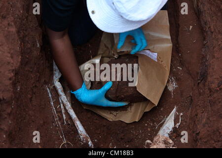 Soweto, South Africa. 11th September 2012. Bones believed to be those of Nceba Sinuma being exhumed on September 11, 2012 at Avalon Cemetery in Soweto, South Africa. Sinuma was one of the “Mofolo 3” who were killed by apartheid agents in a security operation in 1989. The Mofolo 3 were members of the Soweto Youth Congress and were involved in underground uMkhonto weSizwe activities. The body exhumed will be sent for DNA testing. (Photo by Gallo Images / Sowetan / Vathiswa Ruselo/Alamy Live News) Stock Photo