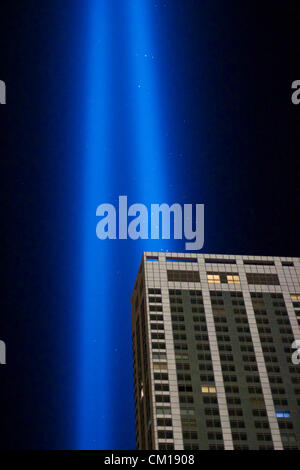 New York, NY - September 11, 2012: The twin columns of light of the installation 'Tribute in Light' rise into the night sky over Manhattan in memory of the 9/11 attacks 11 years ago. Stock Photo