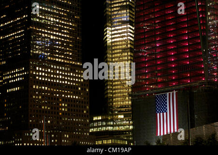 New York, NY - September 11, 2012: The World Trade Center construction site as it is lit in red, white, and blue in memory of the 9/11 attacks 11 years before. Stock Photo
