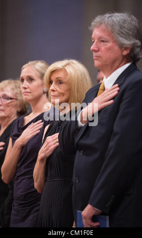 Carol Armstrong, center, her son Eric, right, and daughter Molly Van Wagenen hold their hands to their hearts  during a memorial service celebrating the life of Neil Armstrong September 13, 2012 at the National Cathedral in Washington, DC. Armstrong, the first man to walk on the moon during the 1969 Apollo 11 mission, died August 25. He was 82. Stock Photo