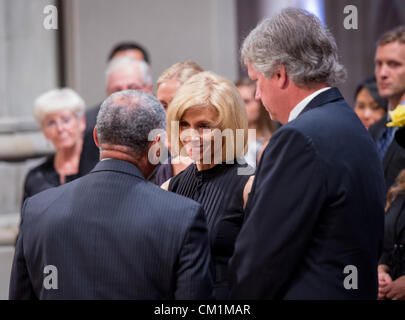 NASA Administrator Charles Bolden, back to camera, speaks with Carol Armstrong after presenting her with a U.S. Flag that was flown at half-mast over Mission Control at Johnson Space Center in Houston, on the day of her husband’s passing, during a memorial service celebrating the life of Neil Armstrong September 13, 2012 at the National Cathedral in Washington, DC. Armstrong, the first man to walk on the moon during the 1969 Apollo 11 mission, died August 25. He was 82. Stock Photo