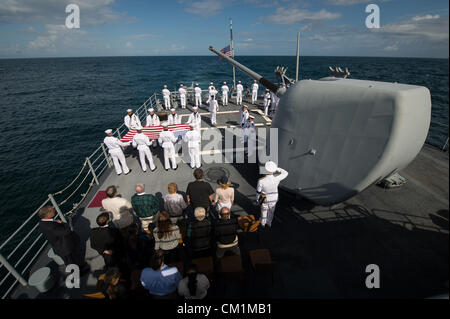 Family members of the late Neil Armstrong and members of the US Navy are seen during the burial at sea service for her husband Apollo 11 astronaut Neil Armstrong September 14, 2012 aboard the USS Philippine Sea in the Atlantic Ocean. Armstrong, the first man to walk on the moon during the 1969 Apollo 11 mission, died August 25. He was 82. Stock Photo