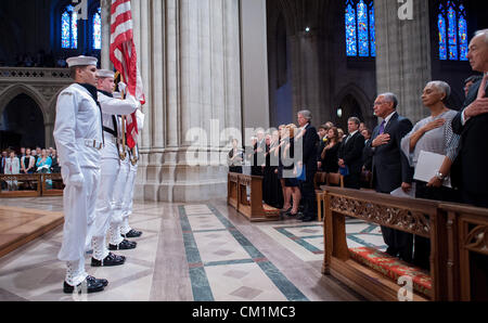 Attendees including from right, John Dalton, Jackie Bolden, Charles Bolden along with the family members of Neil Armstrong on the opposite row stands with their hands over their hearts as a U.S. Navy ceremonial guard stands with the colors during a memorial service celebrating the life of Neil Armstrong September 13, 2012 at the National Cathedral in Washington, DC. Armstrong, the first man to walk on the moon during the 1969 Apollo 11 mission, died August 25. He was 82. Stock Photo