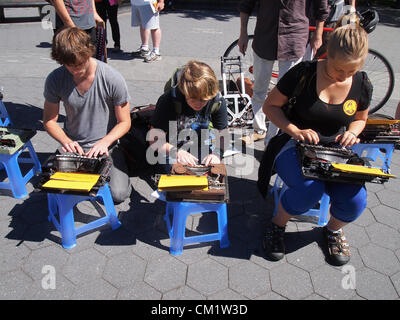 Occupy Wall Street Protesters typing Direction Action Flaneurs on manual typewriters at a gathering in New York City's Washington Square Park on September 15, 2012 to mark the movement's one year anniversary on September 17, 2012.  © Katharine Andriotis Stock Photo