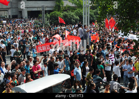 Xian, China. Saturday 15th September, 2012. Anti-Japanese protesters gather during a demonstration at the gate of Bell Tower Hotel in Xi'an,China,on Saturday Sept 15, 2012. Fights broke out between demonstrators and police during a march by more than 10,000 students, who were protesting at the sovereignty of the Fishing Islands(Diaoyu Islands). Stock Photo
