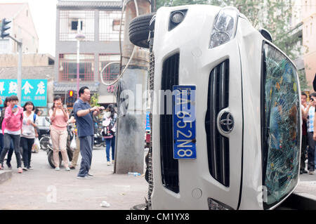 Xian, China. Saturday 15th September, 2012. Anti-Japanese protesters damage and break a Japanese brand TOYOTA  car during a demonstration in downtown Xi'an,China,on Saturday Sept 15, 2012. Fights broke out between demonstrators and police during a march by more than 10,000 students, who were protesting at the sovereignty of the Fishing Islands(Diaoyu Islands). Stock Photo