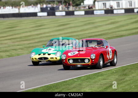 Goodwood Estate, Chichester, UK. 15th September 2012. Arturo Merzario pictured driving a red 1960 Ferrari 250 GT SWB/C followed closely by Alain de Cadnet in a Ferrari 250 GTO during the RAC TT Celebration. The revival is a 'magical step back in time', showcasing a mixture of cars and aviation from the 40's, 50's and 60's and is one of the most popular historical motor racing events in the world. For more information visit www.goodwood.co.uk/revival. Stock Photo