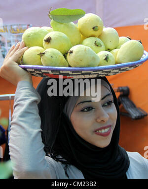 Sept. 17, 2012 - Qalqilya, West Bank, Palestinian Territory - A Palestinian girl carries guava fruits, during the guava festival in the West Bank city of Qalqilya, Sept. 17, 2012  (Credit Image: © Nedal Eshtayah/APA Images/ZUMAPRESS.com) Stock Photo