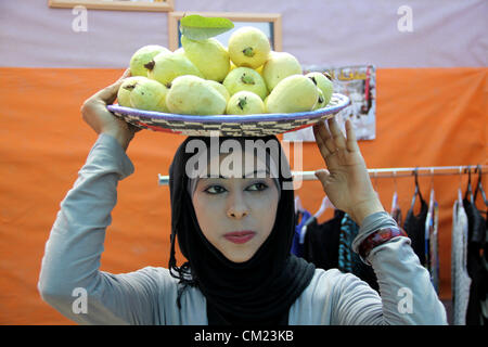 Sept. 17, 2012 - Qalqilya, West Bank, Palestinian Territory - A Palestinian girl carries guava fruits, during the guava festival in the West Bank city of Qalqilya, Sept. 17, 2012  (Credit Image: © Nedal Eshtayah/APA Images/ZUMAPRESS.com) Stock Photo