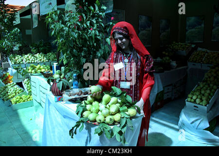 Sept. 17, 2012 - Qalqilya, West Bank, Palestinian Territory - A Palestinian girl wears a traditional dress and displays guava fruits, during the guava festival in the West Bank city of Qalqilya, Sept. 17, 2012  (Credit Image: © Nedal Eshtayah/APA Images/ZUMAPRESS.com) Stock Photo