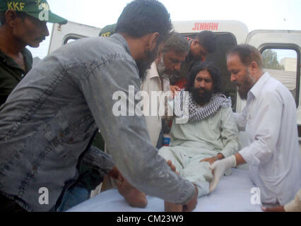 Injure of train collision is being shifted at local hospital in  Karachi on Monday, September 17, 2012. Two person died and atleast ten injured in train  collision accident near Bin Qasim area. Stock Photo