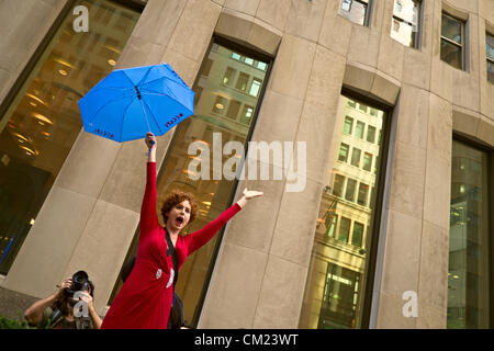 New York, NY, September 17, 2012. On first anniversary of Occupy Wall Street protests, protester with blue umbrella in front of JP Morgan Chase bank at 80 Broadway, New York, NY Stock Photo