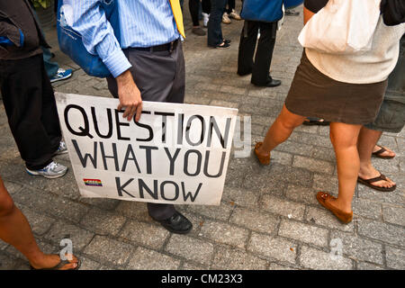 New York, NY, September 17, 2012. On first anniversary of Occupy Wall Street protests, demonstrator holds sign reading 'Question what you know' Stock Photo