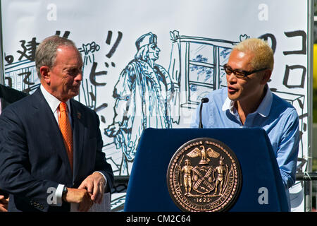 September 19, 2012, New York, NY.  Japanese artist Tatzu Nishi speaking at opening of his installation 'Discovering Columbus,' a living room-like enclosure around the 13-foot statue of Columbus atop a 70-foot column in New York's Columbus Circle.  New York Mayor Michael Bloomberg at left. Stock Photo