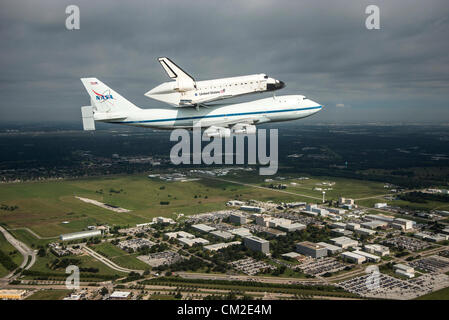 Space Shuttle Endeavour is ferried by NASA's Shuttle Carrier Aircraft September 19, 2012 over the Johnson Space Center in Houston, Texas during a farewell tour on the way to permanent display in Los Angeles. Stock Photo