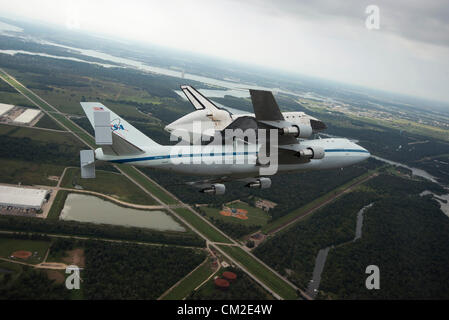 Space Shuttle Endeavour is ferried by NASA's Shuttle Carrier Aircraft September 19, 2012 over Houston, Texas during a farewell tour on the way to permanent display in Los Angeles. Stock Photo