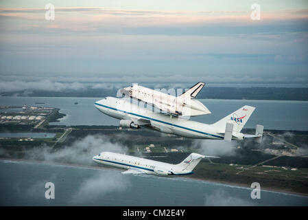 Space Shuttle Endeavour is ferried by NASA's Shuttle Carrier Aircraft September 19, 2012 over the Kennedy Space Center, Cape Canaveral during a farewell tour on the way to permanent display in Los Angeles. Stock Photo