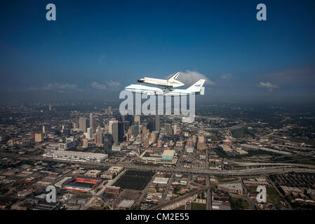 Space Shuttle Endeavour is ferried by NASA's Shuttle Carrier Aircraft September 19, 2012 over Houston, Texas during a farewell tour on the way to permanent display in Los Angeles. Stock Photo