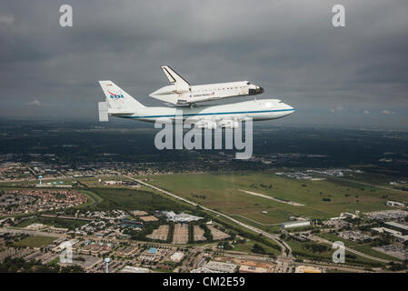 Space Shuttle Endeavour is ferried by NASA's Shuttle Carrier Aircraft September 19, 2012 over Houston, Texas during a farewell tour on the way to permanent display in Los Angeles. Stock Photo