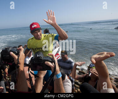 Sept. 20, 2012 - San Clemente, California, USA - KELLY SLATER, of Coco Beach Florida, won the 2012 Hurley Pro at San Onofre State Beach, near San Clemente, California, on Thursday afternoon, September 20, 2012, after a four day battle over 5 days that began Sunday.  In the photo, SLATER is carried from the water's edge on the shoulders of fans and well wishers in a surfing tradition meant to honor a surf contest champion after a win. (Credit Image: © David Bro/ZUMAPRESS.com) Stock Photo