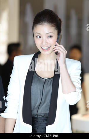 Sept. 21, 2012 - Chiba, Japan - A Japanese actress, Aya Ueto poses with Apple Inc.'s iPhone 5 smartphone at the company's flagship store on Friday, September. 21, 2012 in Tokyo, Japan. Stock Photo