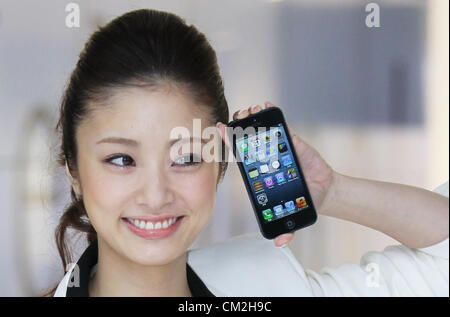 Sept. 21, 2012 - Chiba, Japan - A Japanese actress, Aya Ueto poses with Apple Inc.'s iPhone 5 smartphone at the company's flagship store on Friday, September. 21, 2012 in Tokyo, Japan.  Stock Photo