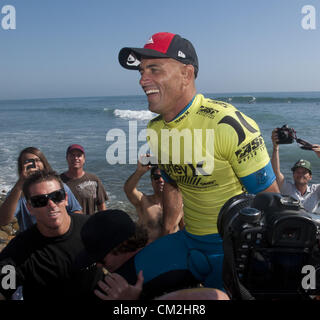 Sept. 20, 2012 - San Clemente, California, U.S. - KELLY SLATER, of Coco Beach Florida, won the 2012 Hurley Pro at San Onofre State Beach on Thursday afternoon. Slater is carried from the water's edge on the shoulders of fans and well wishers in a surfing tradition meant to honor a surf contest champion after a win. (Credit Image: © David Bro/ZUMAPRESS.com) Stock Photo