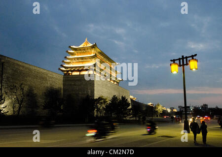 Newly constructed parts of the old city wall are illuminated by lamps in the early evening. The city centre undergoing major construction works on the old wall. The Mayor of Datong’s regeneration programme aims to distance the area from its recent coal-mining fame, and return the area instead to its past glory and historical significance. © Olli Geibel Stock Photo