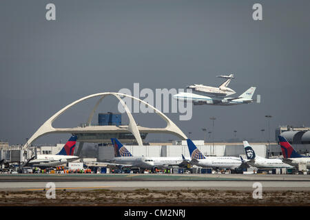 NASA Shuttle Carrier Aircraft carrying space shuttle Endeavour performs a flyby of the Theme Building at Los Angeles International Airport September 21, 2012 on the last California Tour leg of its ferry flight before becoming a static display in Los Angeles. Stock Photo
