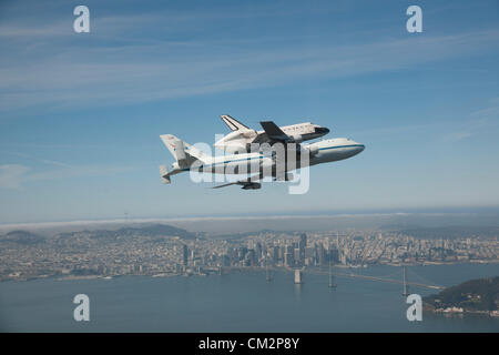 NASA Shuttle Carrier Aircraft carrying space shuttle Endeavour soars over the Bay Bridge in San Francisco, California September 21, 2012 on the last California Tour leg of its ferry flight before becoming a static display in Los Angeles. Stock Photo