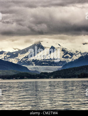 July 5, 2012 - Borough Of Juneau, Alaska, US - Mendenhall Glacier as seen from Auke Bay, Alaska surrounded by the majestic Coast Mountain Range. From 1951â€“1958 the terminus of the glacier, which flows into suburban Juneau, retreated 1,900 feet (580Â m). Since 1958 it has receded 1.75 miles (2.82Â km). Tour buses bring more than 350,000 people a year to see its face, a wall more than 100 feet high and a mile wide. (Credit Image: © Arnold Drapkin/ZUMAPRESS.com) Stock Photo