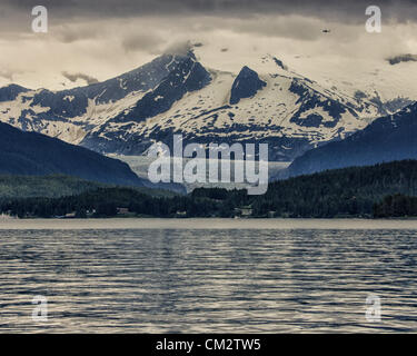 July 5, 2012 - Borough Of Juneau, Alaska, US - Mendenhall Glacier as seen from Auke Bay, Alaska surrounded by the majestic Coast Mountain Range. From 1951â€“1958 the terminus of the glacier, which flows into suburban Juneau, retreated 1,900 feet (580Â m). Since 1958 it has receded 1.75 miles (2.82Â km). Tour buses bring more than 350,000 people a year to see its face, a wall more than 100 feet high and a mile wide. (Credit Image: © Arnold Drapkin/ZUMAPRESS.com) Stock Photo