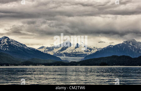 July 5, 2012 - Borough Of Juneau, Alaska, US - Mendenhall Glacier as seen from Auke Bay, Alaska surrounded by the majestic Coast Mountain Range. From 1951â€“1958 the terminus of the glacier, which flows into suburban Juneau, retreated 1,900 feet (580Â m). Since 1958 it has receded 1.75 miles (2.82Â km). Tour buses bring more than 350,000 people a year to see its face, a wall more than 100 feet high and a mile wide. (Credit Image: © Arnold Drapkin/ZUMAPRESS.com) Stock Photo