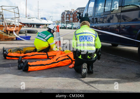 Bangor, County Down. 23/09/2012 - PSNI officer and Ambulance crew identify recovered dummy bodies. Emergency Services hold 'Operation Diamond', a joint training exercise off the coast of North Down. During the operation, a simulated crash between a ferry carrying 65 passengers and crew and a smaller boat enabled all branches of the emergency services to coordinate actions. Stock Photo