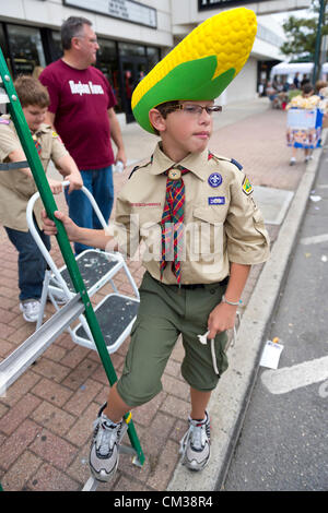 Sept. 22, 2012 - Bellmore, New York U.S. - Wearing a large Corn on the Cob hat, is cub scout from North Bellmore Cub Scout Troop 313, as troop sells popcorn to raise funds at the 26th Annual Bellmore Family Street Festival. More people than the well over 120,000 who attended the Long Island fair last year were expected. Stock Photo