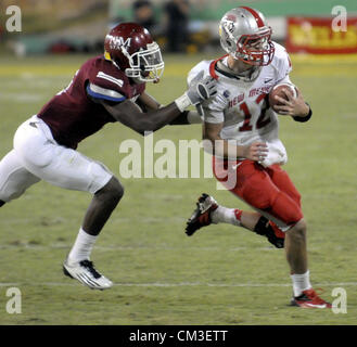 Sept. 22, 2012 - Las Cruces, NM, U.S. - Greg Sorber -- Lobo quarterback B.R. Holbrook, 12, is pursued by the Aggies'  George Callender, 5, during the game in Aggie Memorial Stadium in Las Cruces on Saturday, September 22, 2012. (Credit Image: © Greg Sorber/Albuquerque Journal/ZUMAPRESS.com) Stock Photo