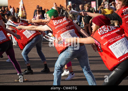 Bournemouth, UK Saturday 29 September 2012. Opening day of the Bournemouth Arts by the Sea Festival - the Big Issue Vendor Flash Mob perform. Lee Hart, Director of Salt Factory, worked with local Big Issue vendors to develop choreography which tells their stories. Stock Photo