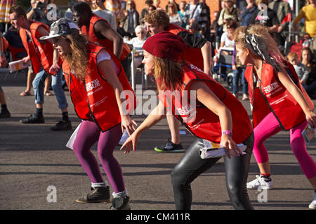 Bournemouth, UK Saturday 29 September 2012. Opening day of the Bournemouth Arts by the Sea Festival - the Big Issue Vendor Flash Mob perform. Lee Hart, Director of Salt Factory, worked with local Big Issue vendors to develop choreography which tells their stories. Stock Photo