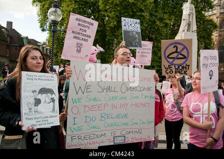 London, UK. 29/09/12. Pro-Choice campaigners surround a pro-life counter- protester whilst holding a rally opposite the Houses of Parliament to highlight the fact that abortion is outlawed in Northern Ireland and that abortion law in the UK is outdated. Stock Photo