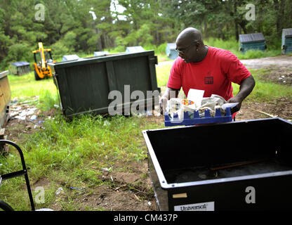 Aug. 23, 2012 - Sapelo Island, Georgia, U.S. - Sapelo Island resident MAURICE BAILEY deposes of trash at the dump. State of Georgia Department of Natural Resources employees and residents must maintain the site. (Credit Image: © Stephen Morten/zReportage.com/ZUMA) Stock Photo