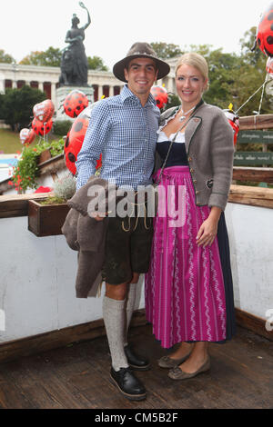 MUNICH, GERMANY - OCTOBER 07:  Philipp Lahm of FC Bayern Muenchen attends with his wife Claudia Lahm the Oktoberfest beer festival at the Kaefer Wiesnschaenke tent on October 7, 2012 in Munich, Germany. Stock Photo