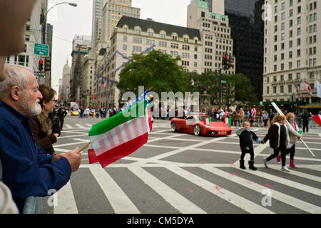 New York, NY, October 8, 2012.   Man in crowd holds US and Italian flags as he watches New York City's annual Columbus Day parade up 5th Avenue. Stock Photo