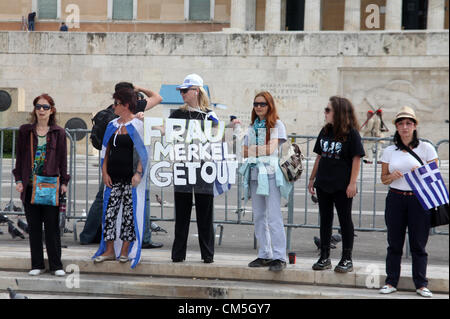 Tuesday 09 October 2012  Pictured: Female protesters with a 'Frau Merkel Get Out placard' in Syntagma Square, infront of the Greek Parliament.  Re: German Chancellor Angela Merkel has pledged her country's continuing support to Greece, during her first visit to Athens since the eurozone crisis erupted nearly three years ago.  Mrs Merkel said Greece had made good progress in dealing with its vast debt but that it was on a 'difficult path'.  Thousands of people who blame Germany for forcing painful austerity measures on Greece are protesting in Athens.  Police have used teargas and stun grenades Stock Photo