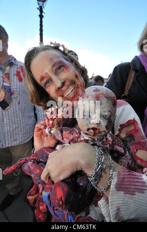 Southbank, London, UK. 13th October 2012. A  'Zombie'  mother and child. World Zombie Day, a Zombie themed pub crawl through central London. Hundreds of people dressed as Zombies make their way through London on a day long charity pub crawl. Stock Photo